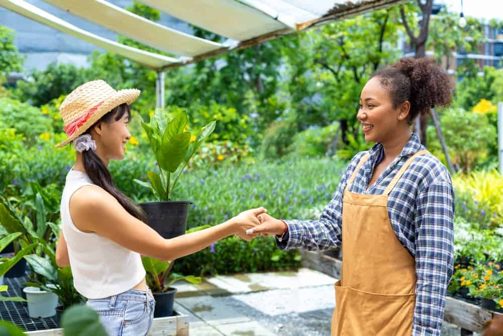 Customer shaking hands with the local gardener after getting plants for free.